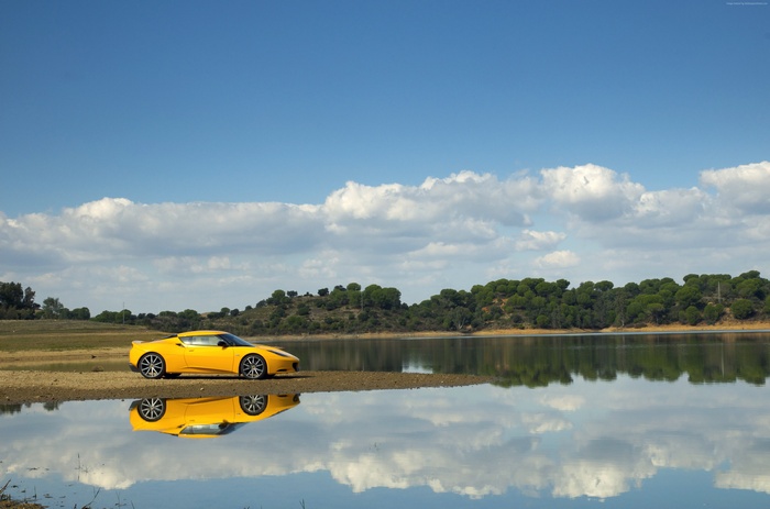Yellow Lotus Evora S parked by a lake
