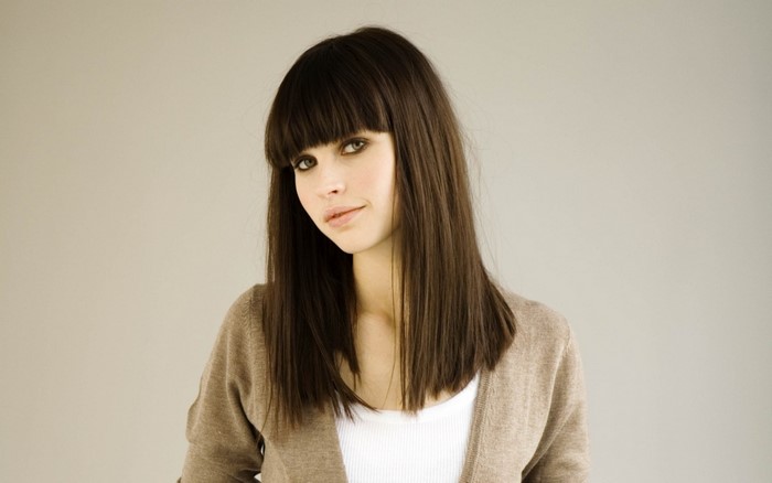 Felicity Jones portrait with straight brown hair and bangs
