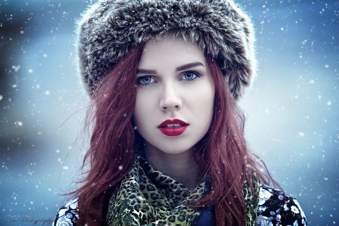 Woman with red hair and blue eyes wearing a fur hat