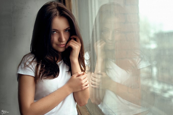 Brunette Woman by Window Reflecting Soft Light