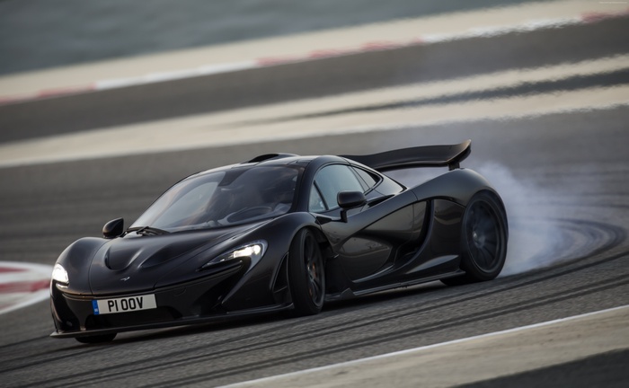 Black McLaren P1 GTR drifting on a race track