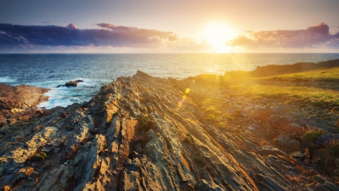 Sunset over rocky coast and ocean