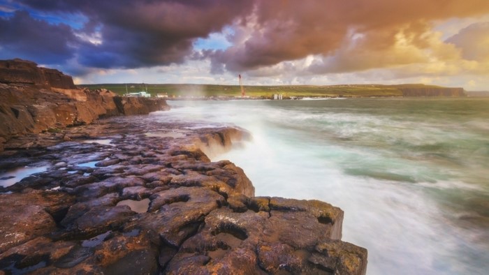Rocky coast with waves crashing during sunset