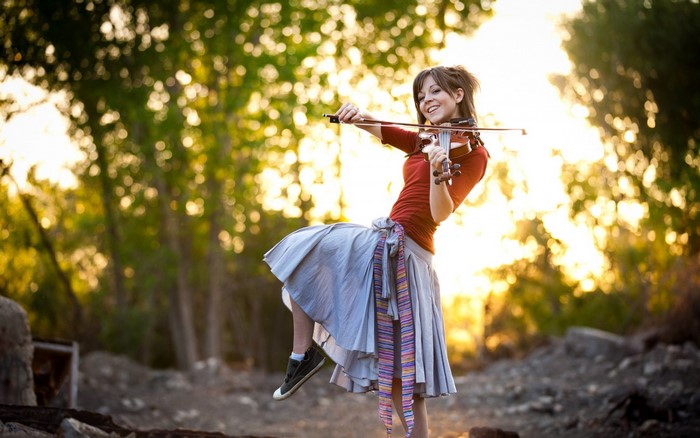Woman playing violin outdoors