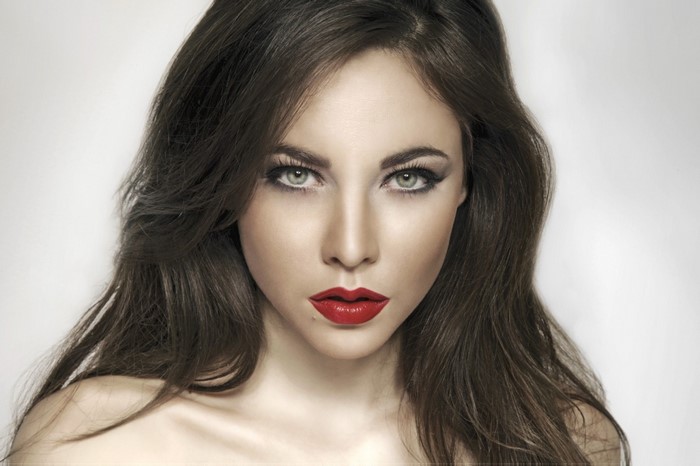 Woman with long brown hair and red lipstick