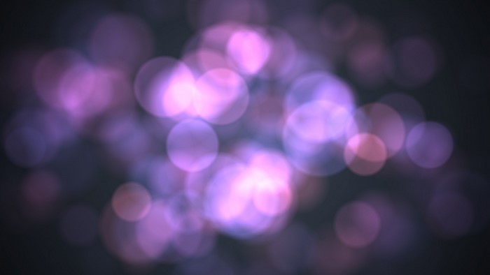 Purple and pink bokeh lights on dark background