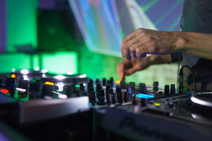 DJ hands mixing music on Pioneer turntables