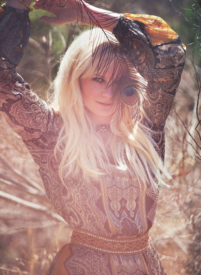 Kirsten Dunst with a peacock feather