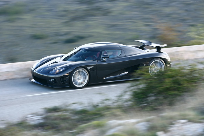 Black Koenigsegg CCXR driving on a road