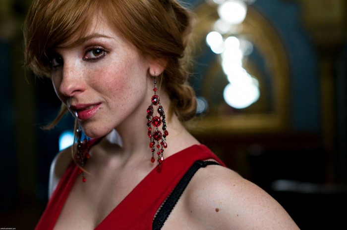 Vica Kerekes portrait with red dress and earrings