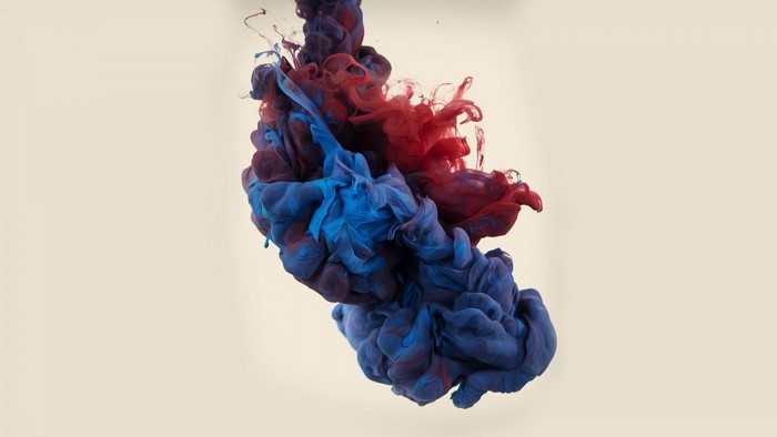 Red and blue ink swirling in water