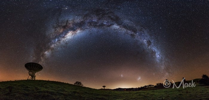 Milky Way galaxy over radio telescopes on a hill at night