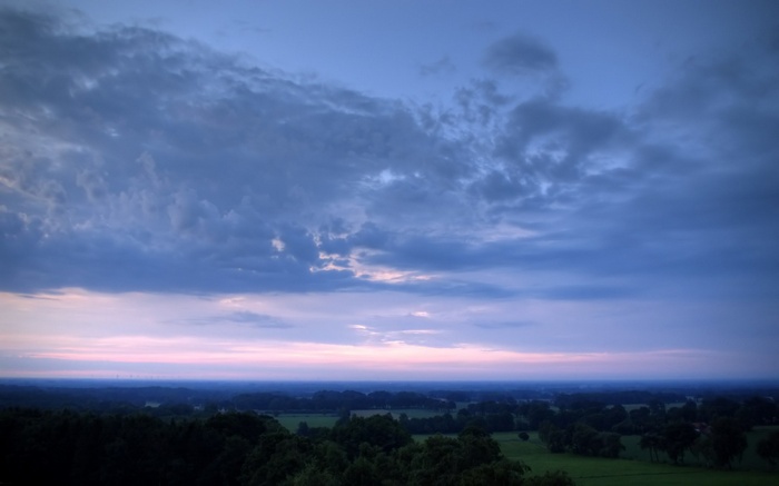 Dark clouds over a twilight landscape