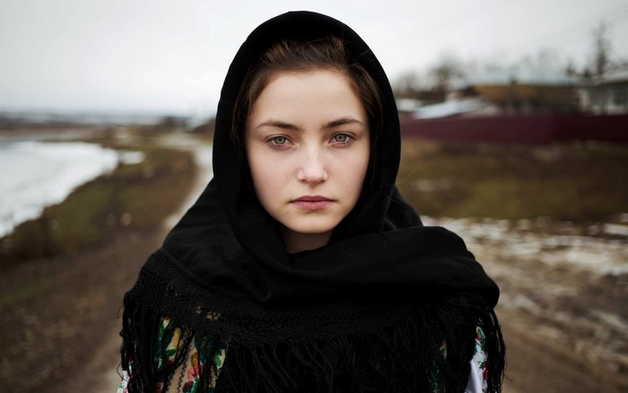 Young woman wearing a black headscarf and traditional dress