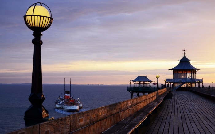 Paddle Steamer on the Sea by a Pier at Sunset