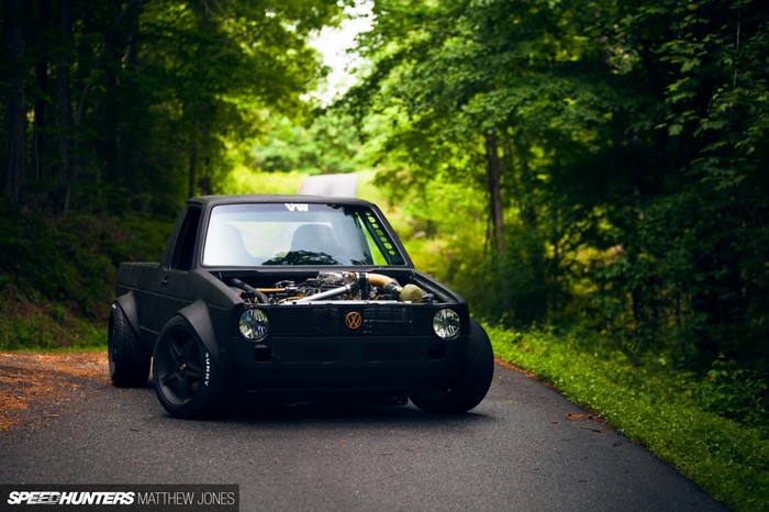 Modified black Volkswagen pickup truck on a road
