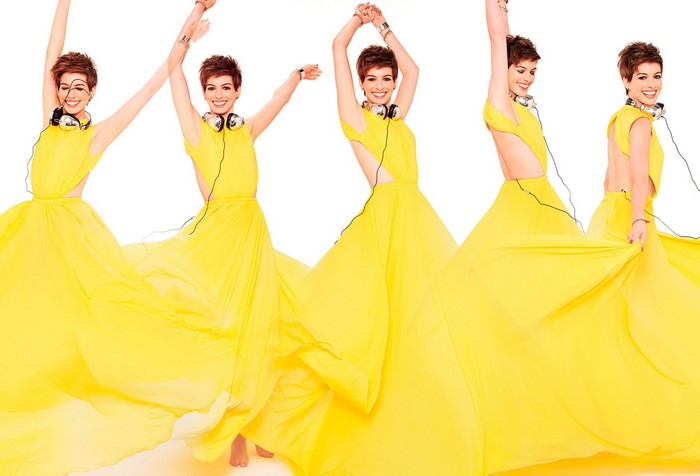 Anne Hathaway in a yellow gown with headphones