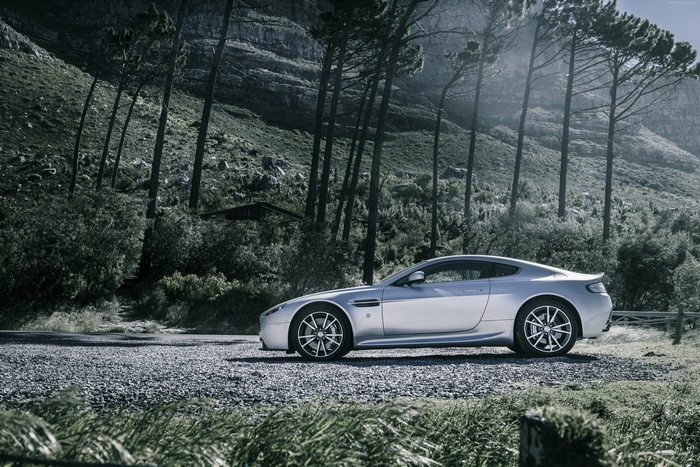 Silver Aston Martin V8 Vantage parked on gravel road