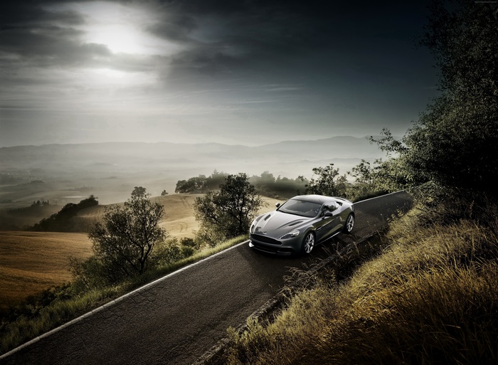 Aston Martin Vanquish on a winding road in Tuscany