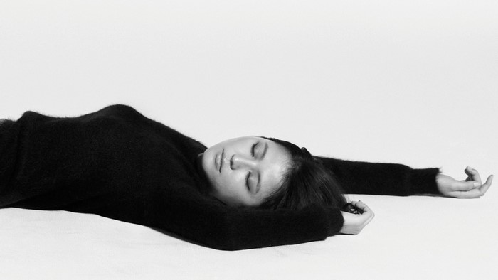 Masami Nagasawa lying down in black clothing