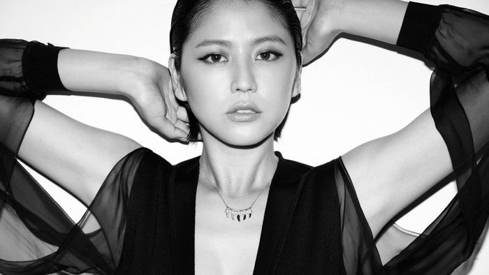 Masami Nagasawa in black clothing with necklace