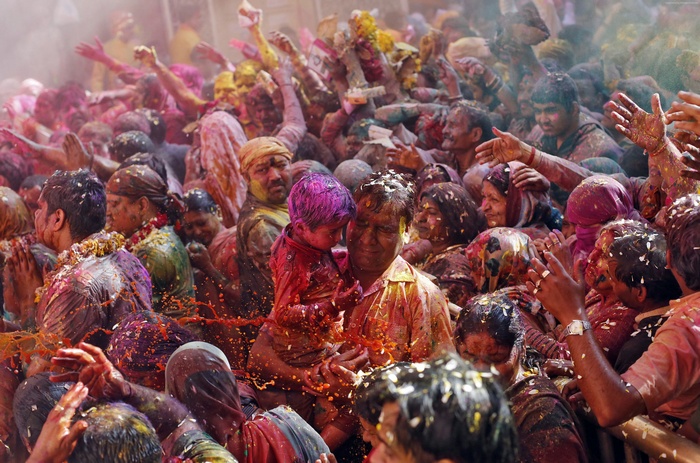 People celebrating Holi with colored powder