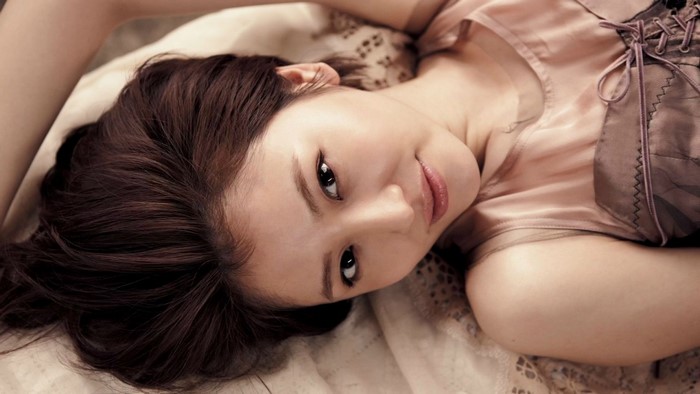 Portrait of Asian Woman with Long Hair Lying Down