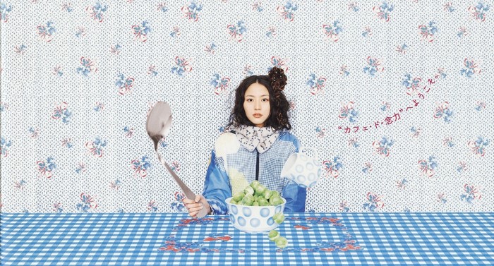 Woman with spoon and bowl of peas