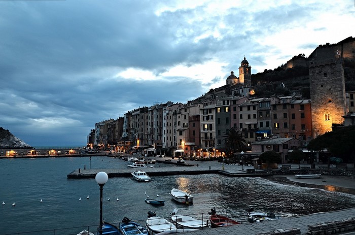 Coastal town with harbor and boats at dusk