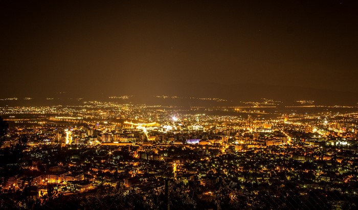 Cityscape at night with glowing lights from above