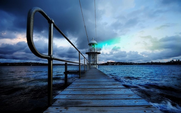 Pier leading to a lighthouse at dusk