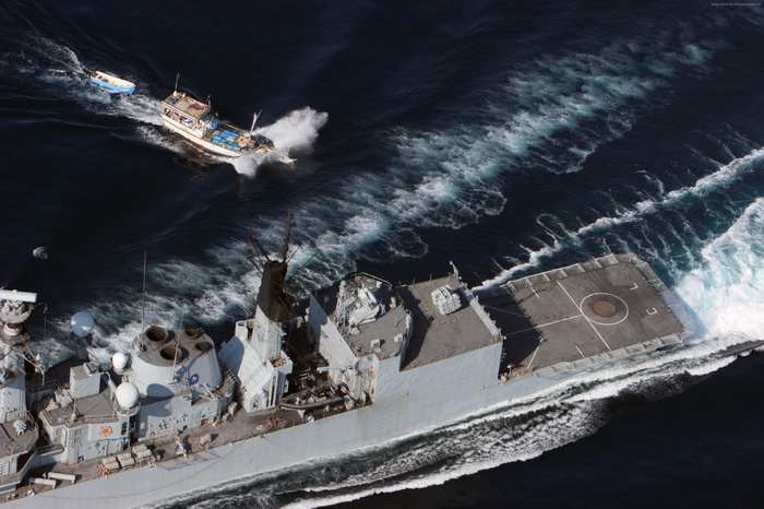 HMS Cumberland frigate and fishing boats at sea