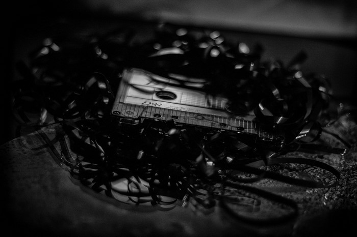 Monochrome close-up of a tangled cassette tape