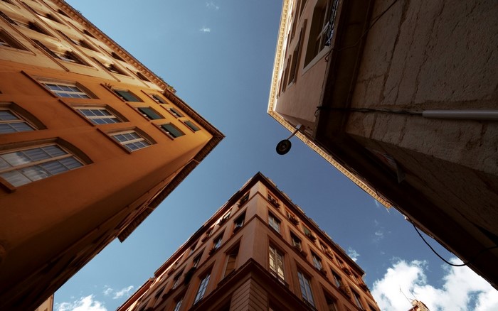 Buildings viewed from below against a blue sky