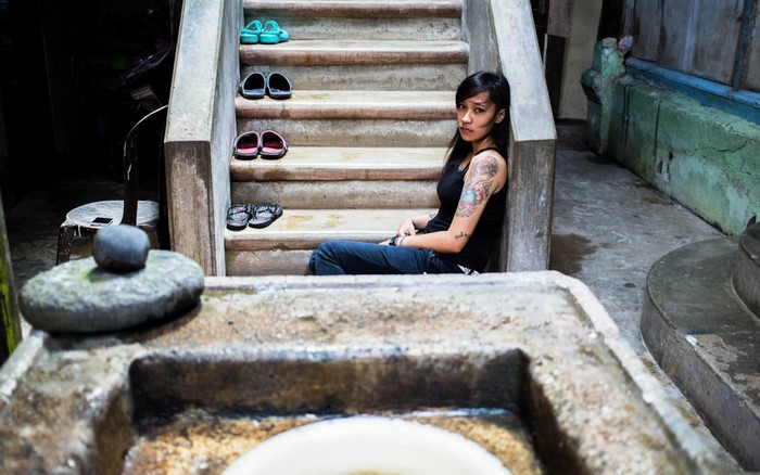 Woman sitting on stairs with sandals