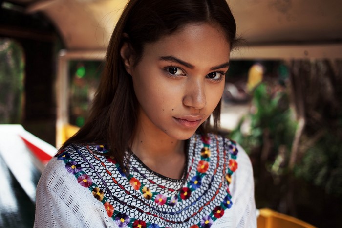 Woman in embroidered dress looking at the camera