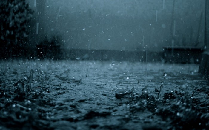 Rain falling on the ground at night