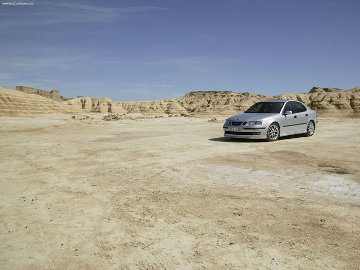 Silver Saab 9-3 sedan in a desert landscape