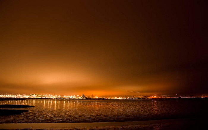 City lights reflecting on the water at dusk