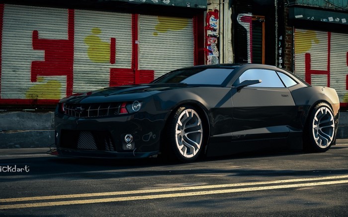 Black Chevrolet Camaro parked on a street with graffiti