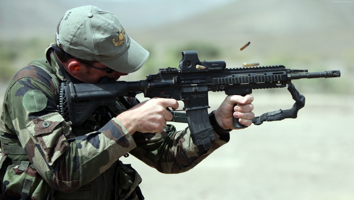 Soldier firing Heckler & Koch HK416 assault rifle