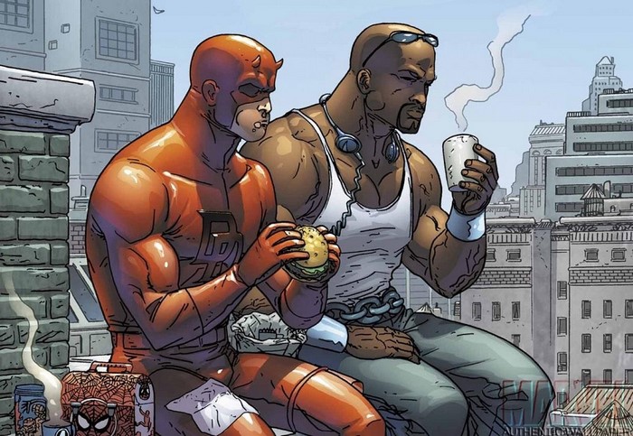 Daredevil and Luke Cage eating on a rooftop