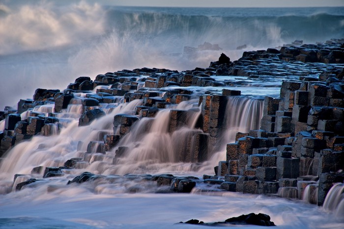 Waterfalls cascading over basalt columns at Giants Causeway