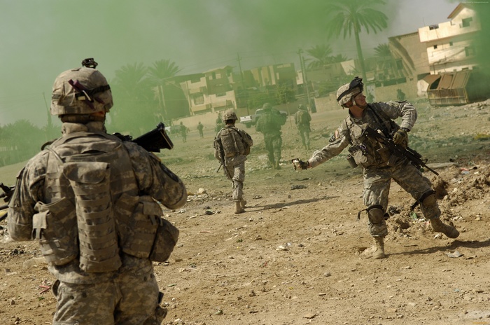 U.S. Army soldiers in Iraq with smoke grenade