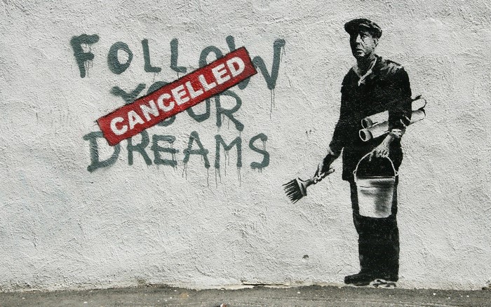 Banksy graffiti: Man painting 'Follow Your Dreams Cancelled'