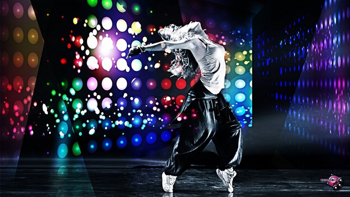 Dancer performing on a stage with colorful lights
