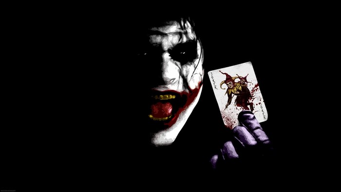 The Joker holding a bloody Joker card