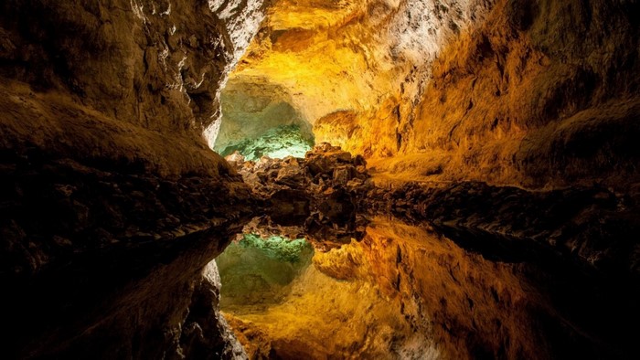 Cave with water reflection and rock formations
