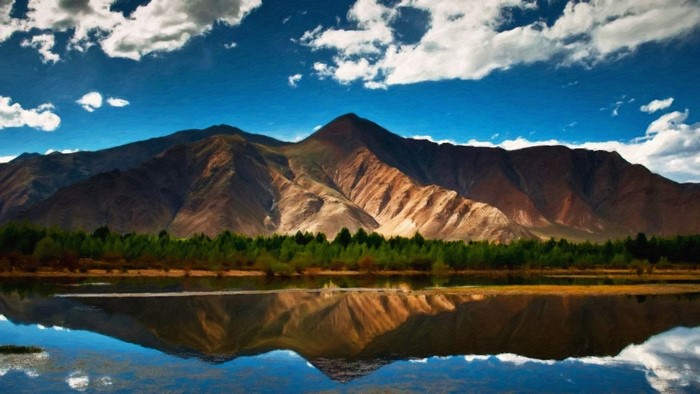 Mountain range reflected in a lake with clouds