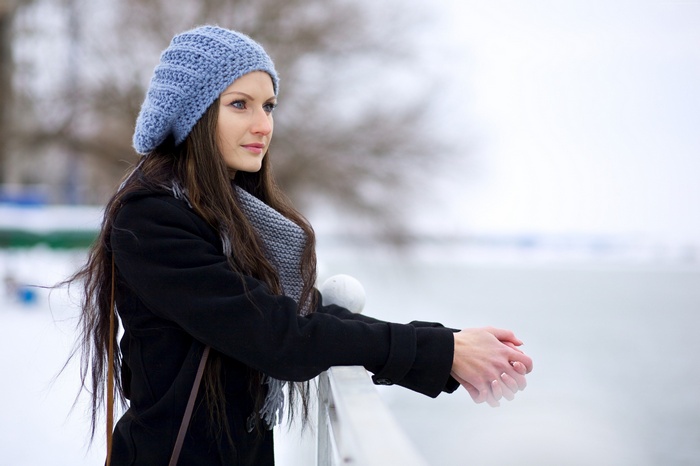 Justyna Gradek wearing a blue hat and black coat